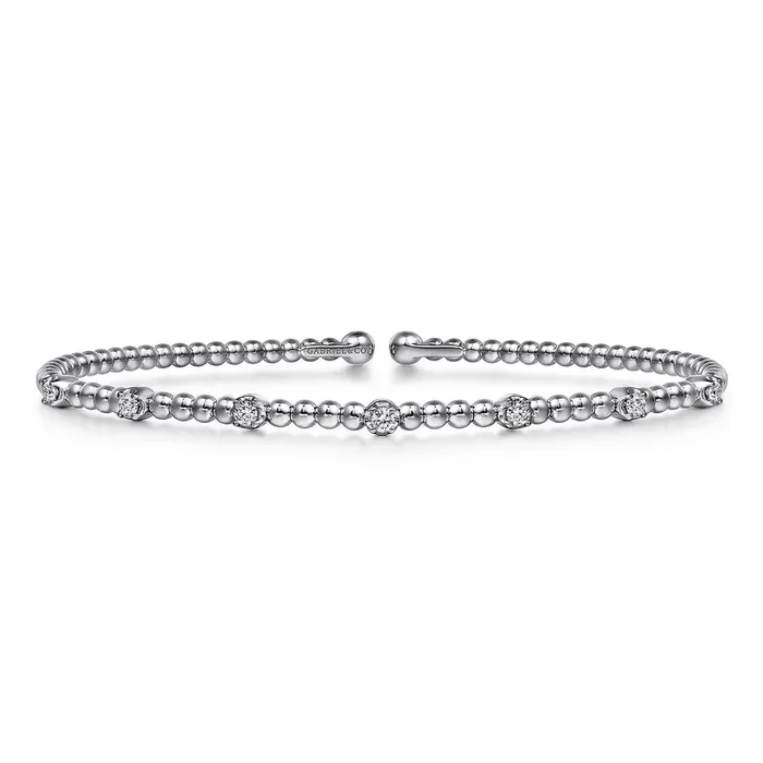 Flex cuff bangle set with 7 diamonds across the top in stations 14kt white gold by Gabriel